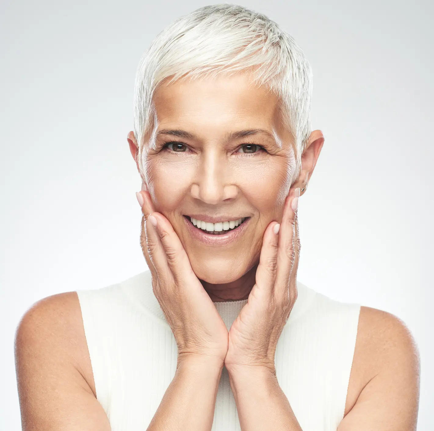 Senior woman posing in front of gray background. SkinPen® in Indianapolis, Indiana
